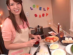 Smiley Japanese babe giving her man superb blowjob before having her pussy drilled with toy in the kitchen
