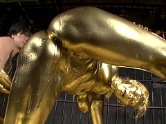 She is covered in gold paint then she gets fucked by a golden guy