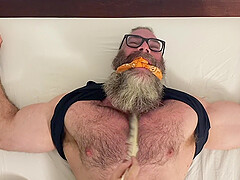 Muscular older dude tied up to a bed and licked by his best friend